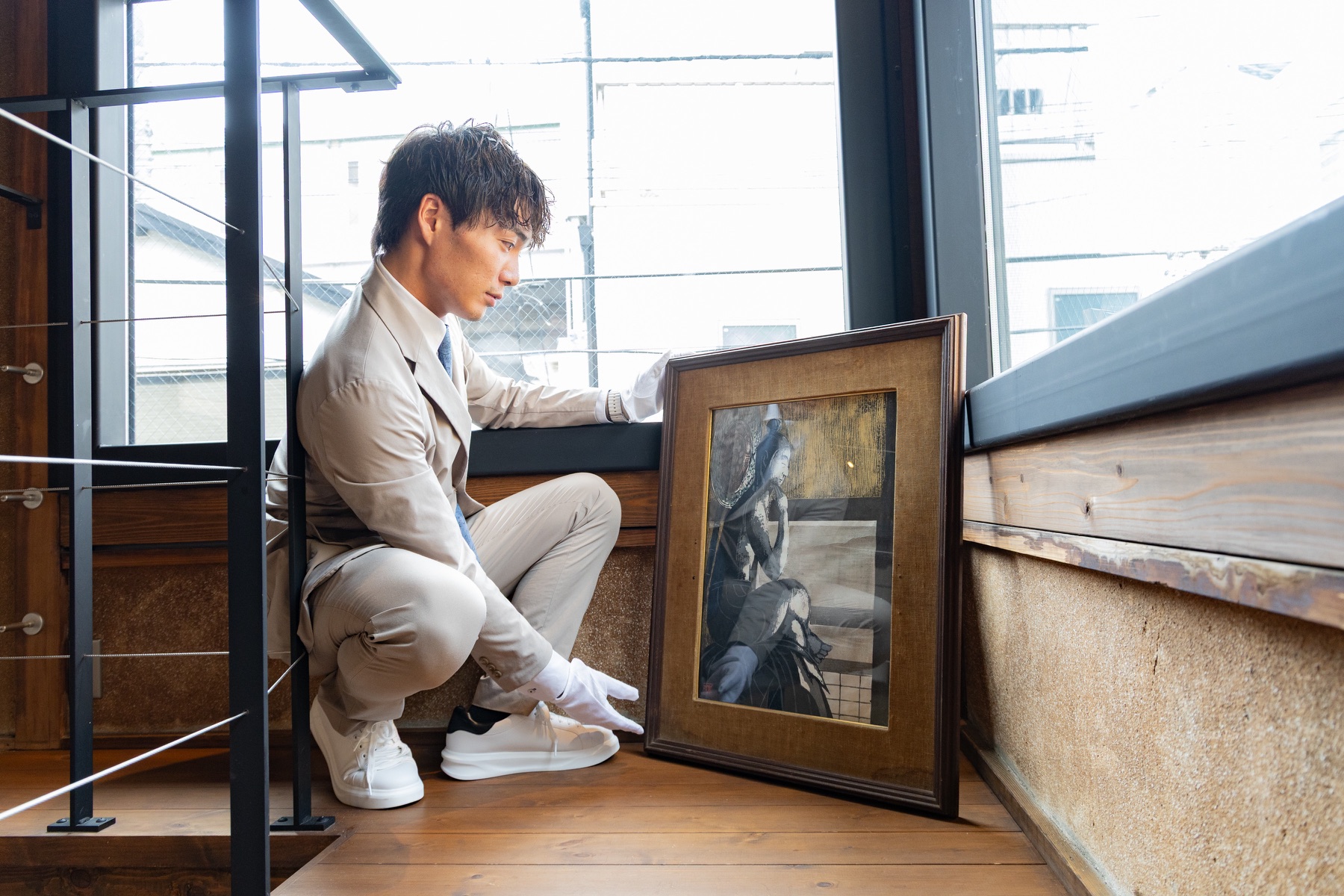 額装された美術品を確認する担当者